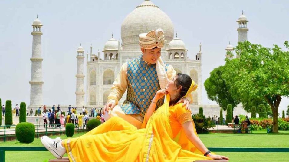 taj-mahal-couple-royal-attire-yellow-lehenga-agra-crystal-india-holidays.jpg