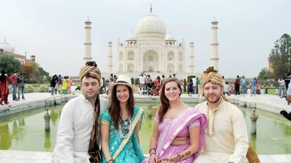taj-mahal-tourist-group-turban-lehenga-reflection-pool-agra-crystal-india-holidays.jpg